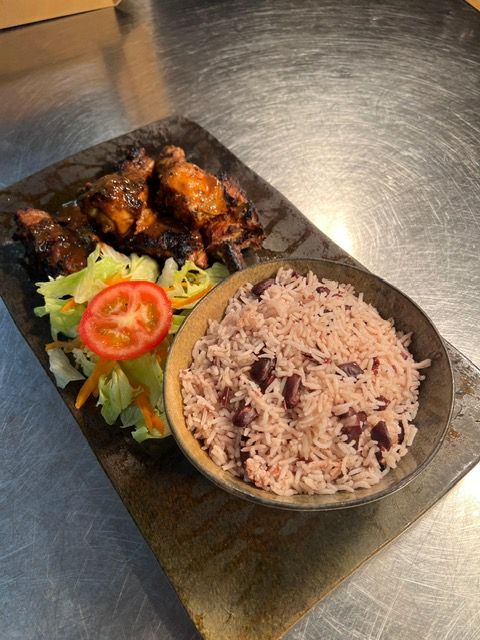 Jerk chicken with rice and peas and salad